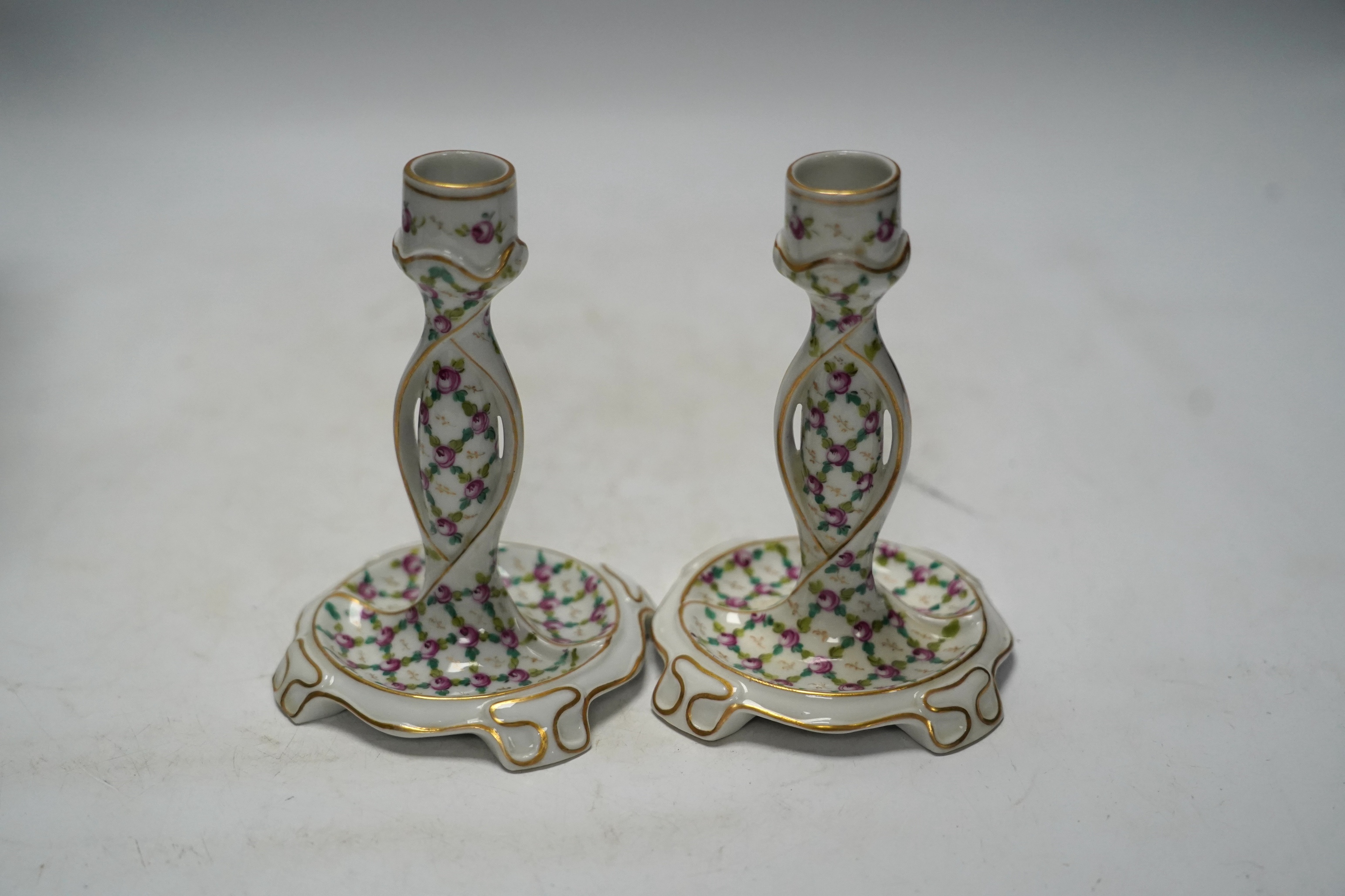 A porcelain shell-shaped centrepiece, a Dresden pill box, a pair of taper holders and a porcelain figure, tallest 21cm
